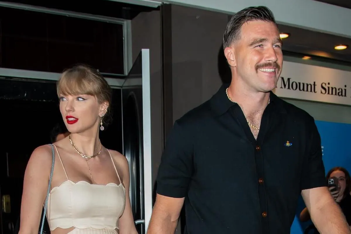 Taylor Swift, who wants Travis Kelce to be more than her 'muse,' walks with Travis Kelce.