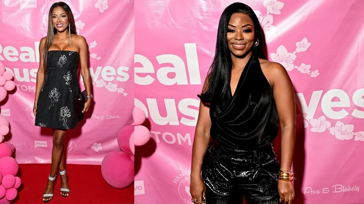 Both wearing black outfits, Stacey Rusch and Keiarna Stewart stand on the red carpet surrounded by pink