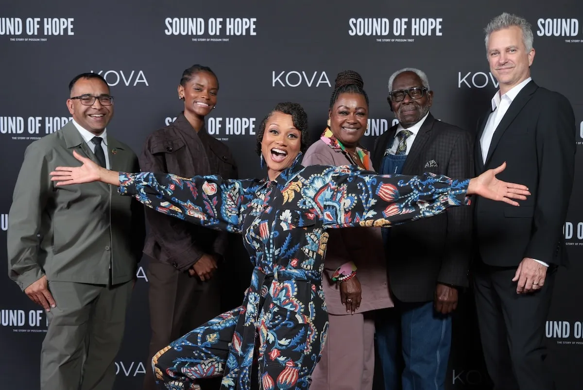 The team behind Possum Trot, Krish Kandiah, Letitia Wright, Nika King, Donna Martin, Bishop Wilbert Martin, and Josh Weigel, stand together on the red carpet