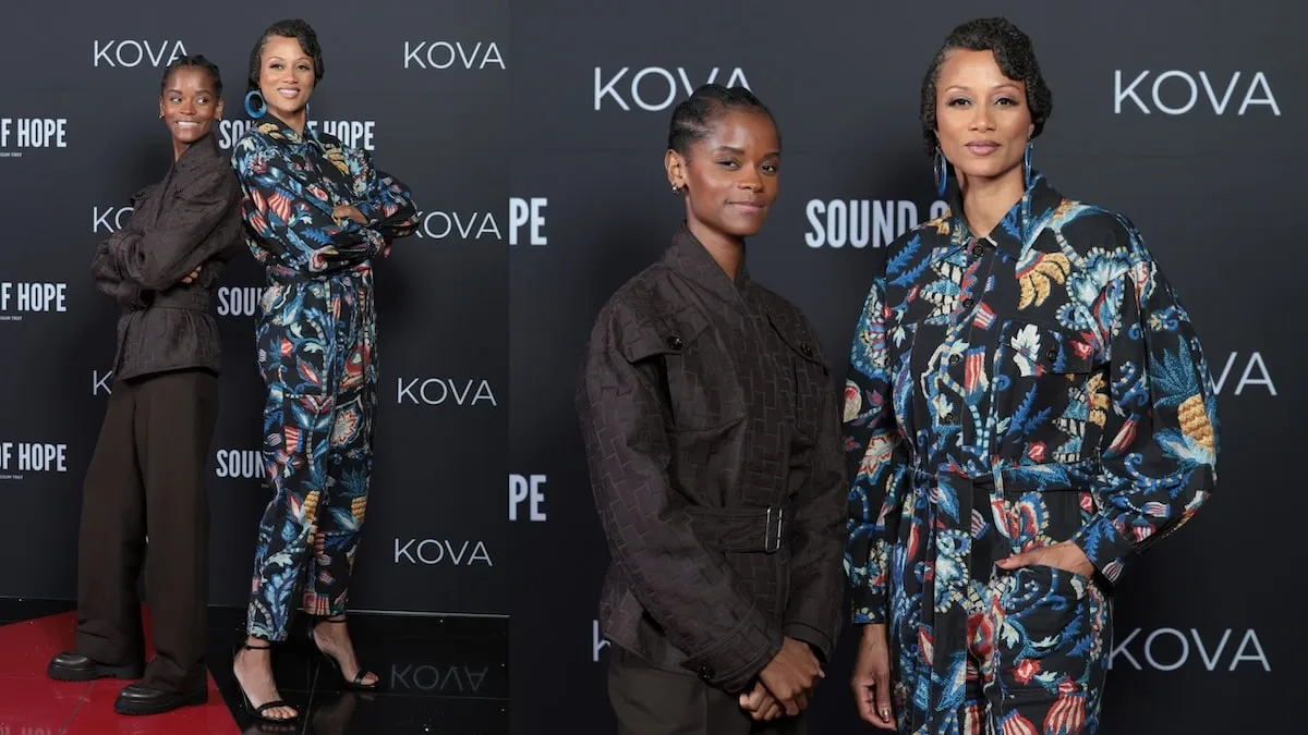 Possum Trot co-stars Letitia Wright, wearing a brown suit, and Nika King, wearing a flowery jumpsuit, stand together on the red carpet