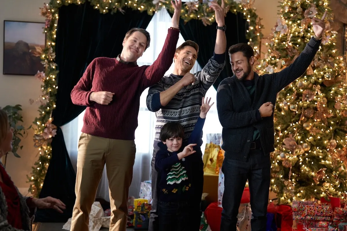 Three men and a little boy performing a choreographed dance in the Hallmark movie 'Three Wiser Men and a Boy'