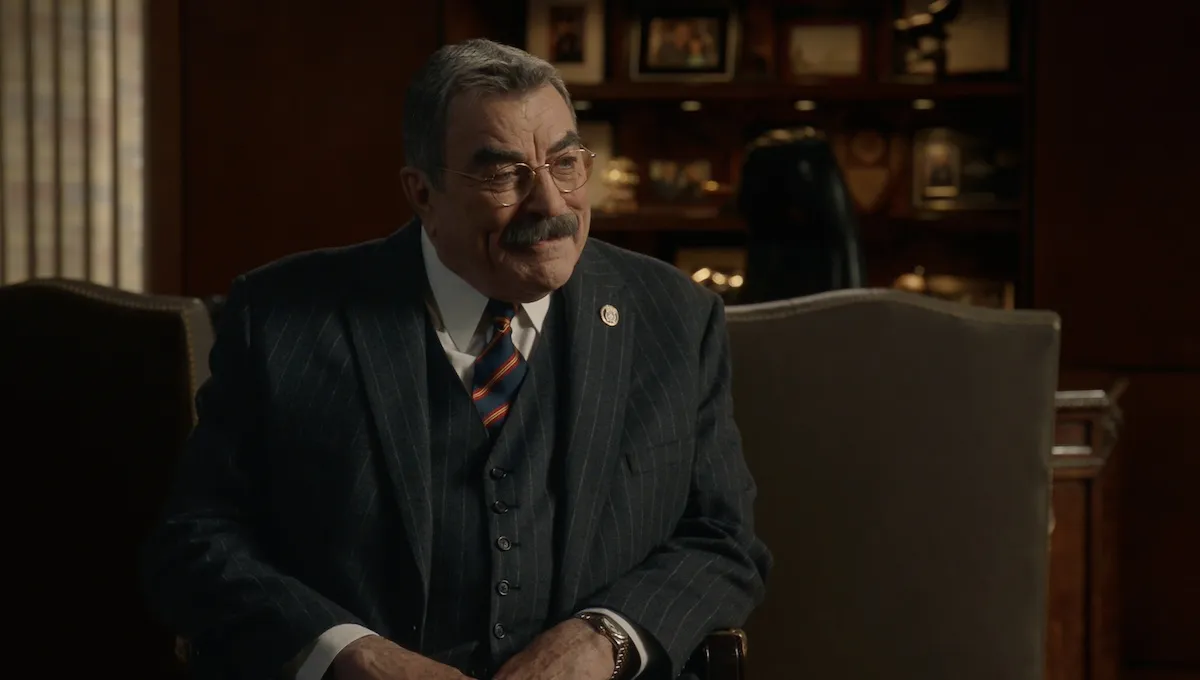 Smiling Frank Reagan (Tom Selleck) wearing a suit in 'Blue Bloods'