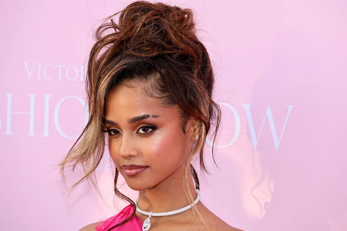 Wearing a deconstructed hot pink gown, Tyla walks the pink carpet before the Victoria's Secret runway show