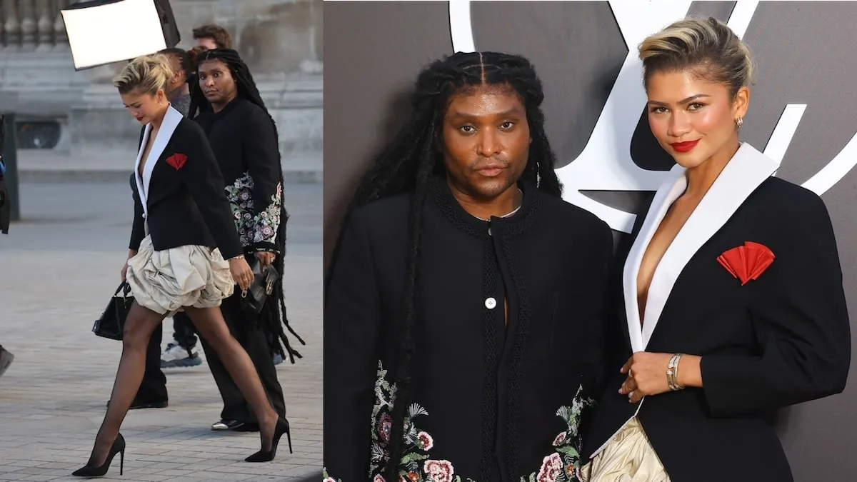 Wearing a black blazer and beige bubble skirt, Zendaya smiles for cameras and walks across the plaza before the Louis Vuitton show