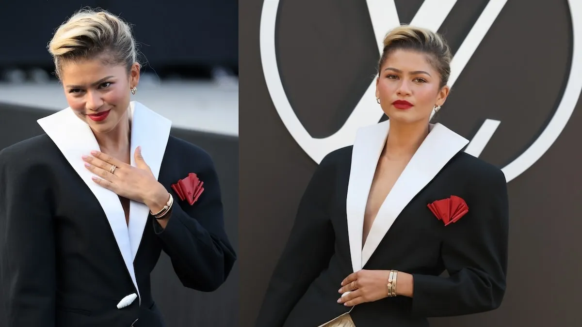 Wearing a black blazer and beige bubble skirt, Zendaya poses on the red carpet and smiles