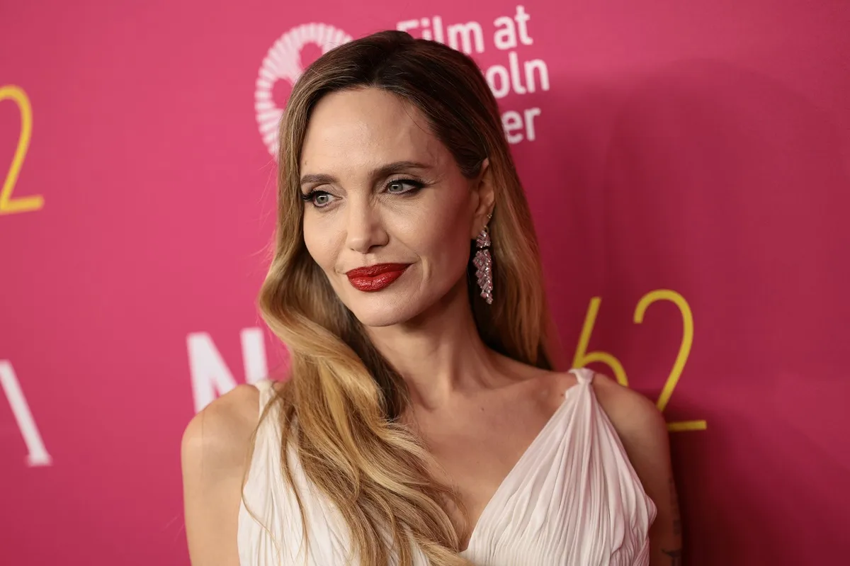 Angelina Jolie posing at the premiere of 'Maria' in a dress.