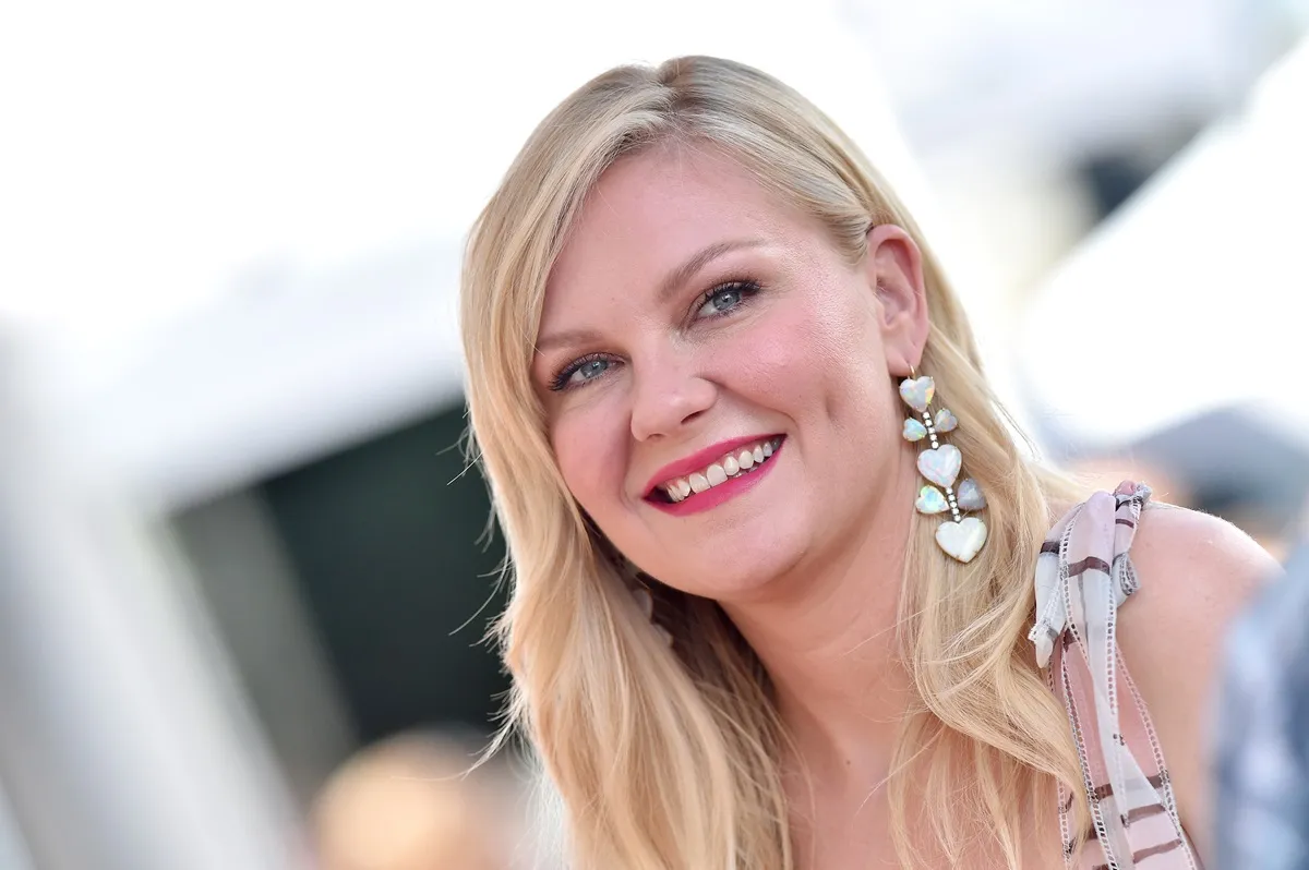 Kirsten Dunst posing at The Hollywood Walk of Fame ceremony.