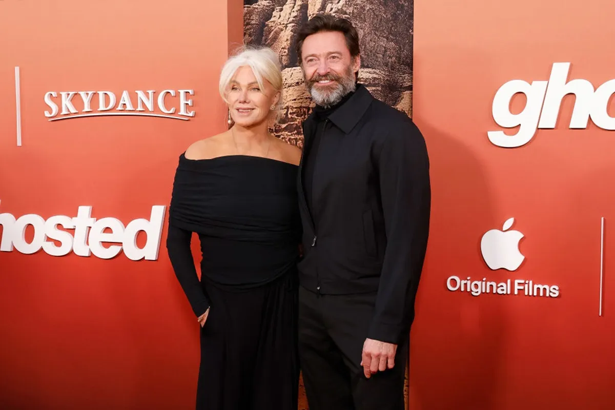 Deborra-Lee Furness and Hugh Jackman posing in matching-colored outfits at 'Ghosted' premiere.