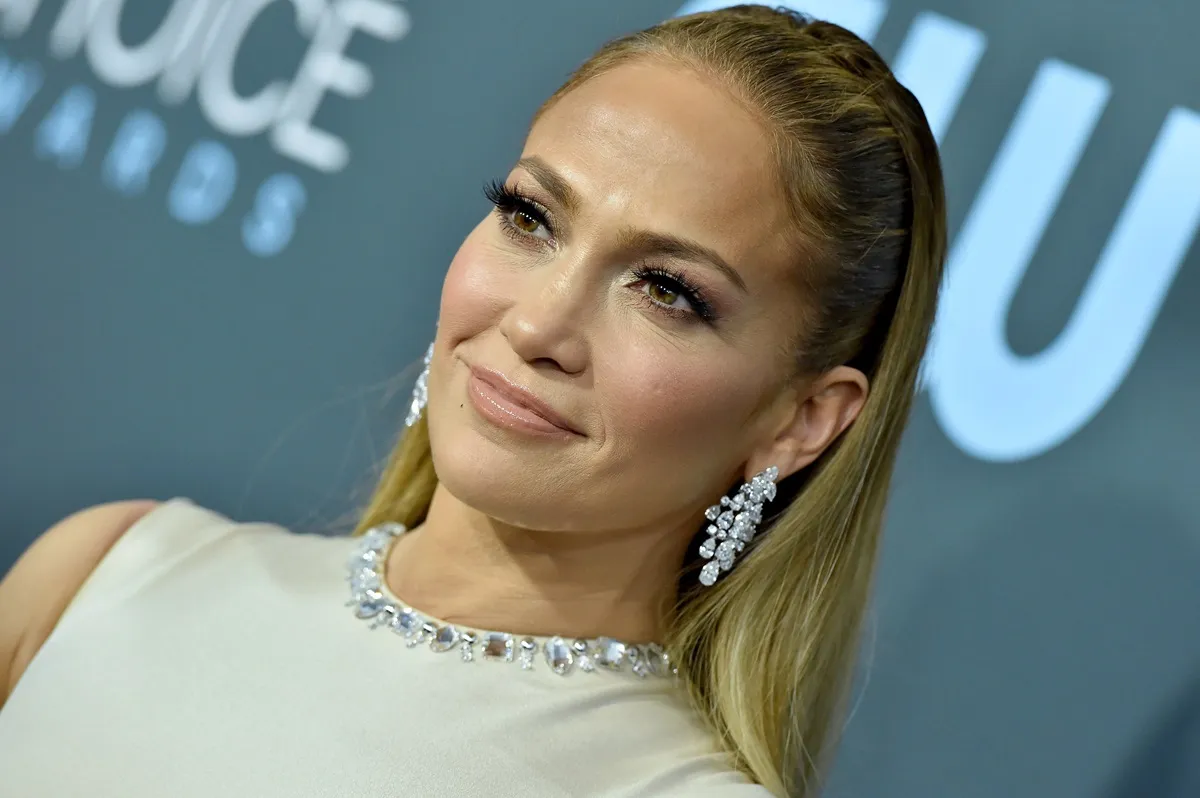 Jennifer Lopez attends the 25th Annual Critics' Choice Awards while wearing a white dress.