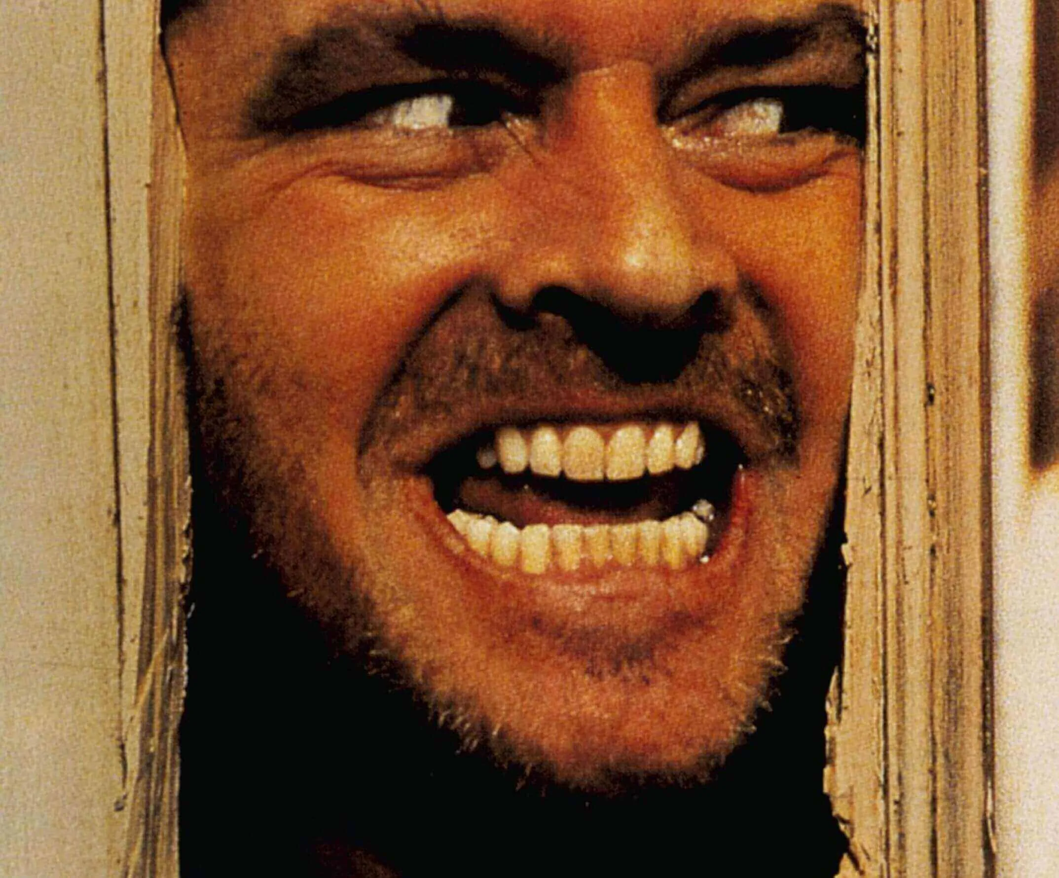 Jack Nicholson smiling while playing Jack Torrance, his most famous horror movie performance