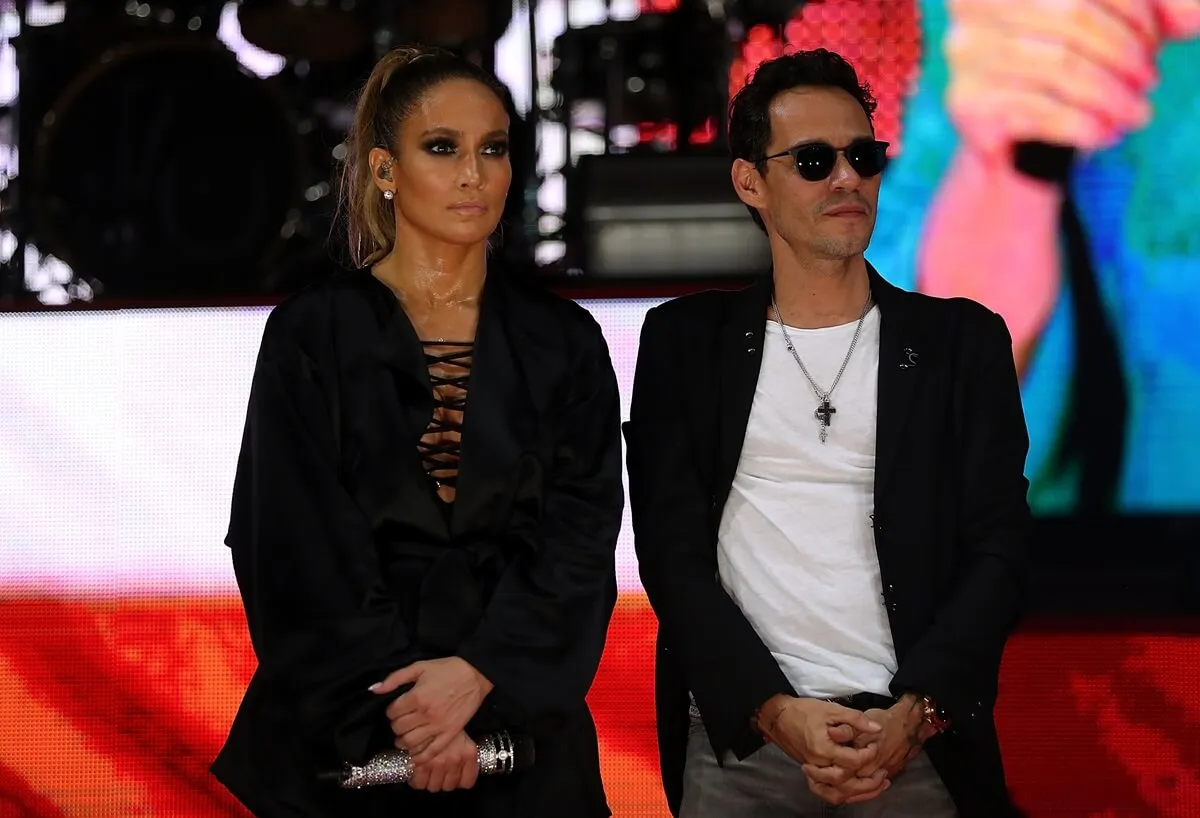 Jennifer Lopez and Marc Anthony posing together on stage at the Get Out the Vote concert.