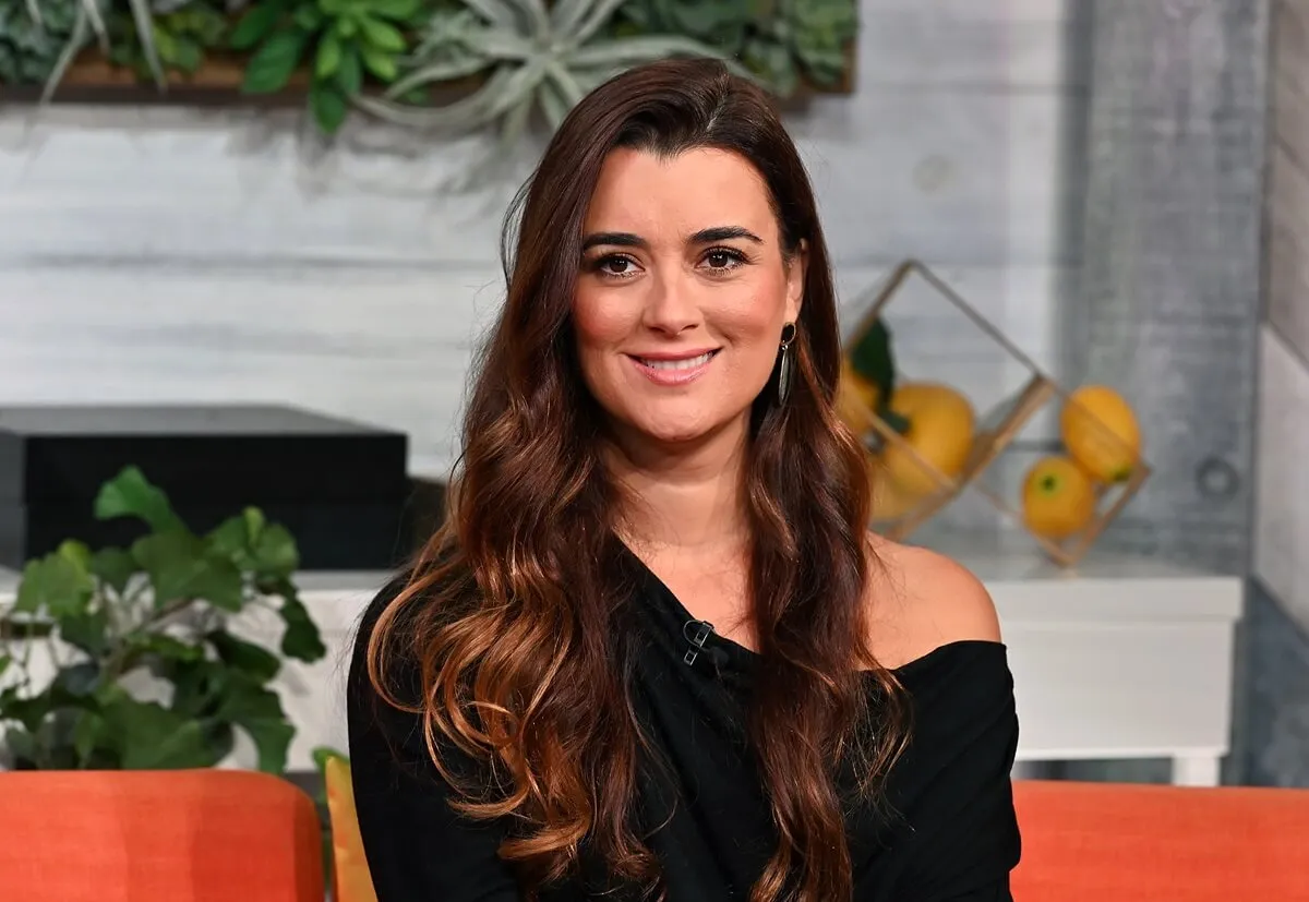 Cote de Pablo talking to Buzzfeed while wearing a black shirt.