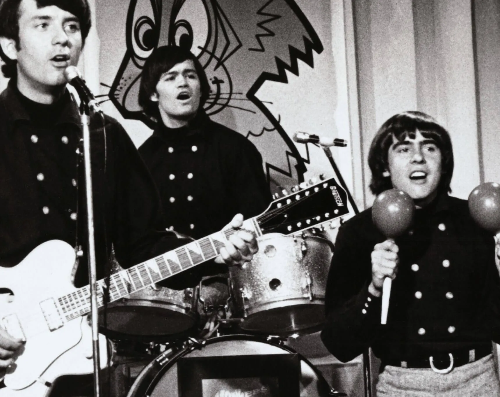 A black-and-white photo of The Monkees playing songs