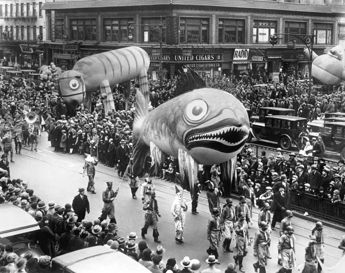 A black and white photo of a giant fish balloon during the 1928 Macy's Thanksgiving Day parade