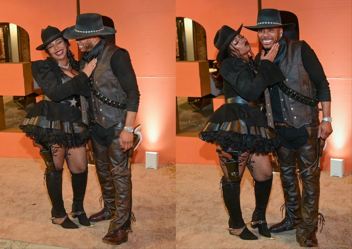 Wearing black cowboy costumes, Nelly and Ashanti smile for a photo at their Halloween party