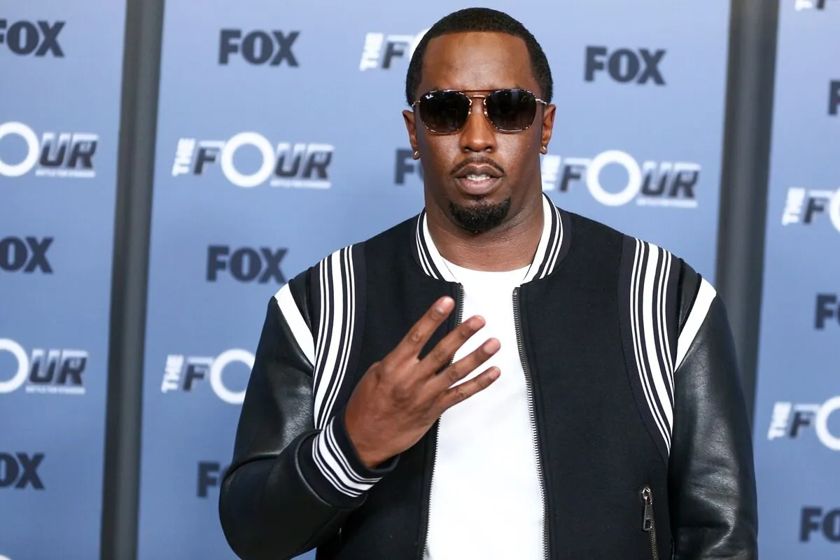 Sean Diddy Combs posing in a coat and white t-shirt at the premiere of Fox's "The Four: Battle For Stardom" season 2.