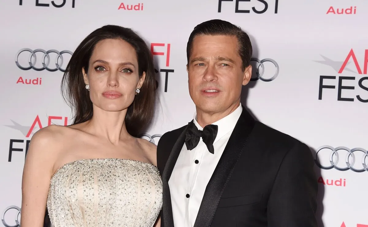 Brad Pitt posing alongside Angelina Jolie at the AFI FEST 2015 presented by Audi Opening Night Gala Premiere.