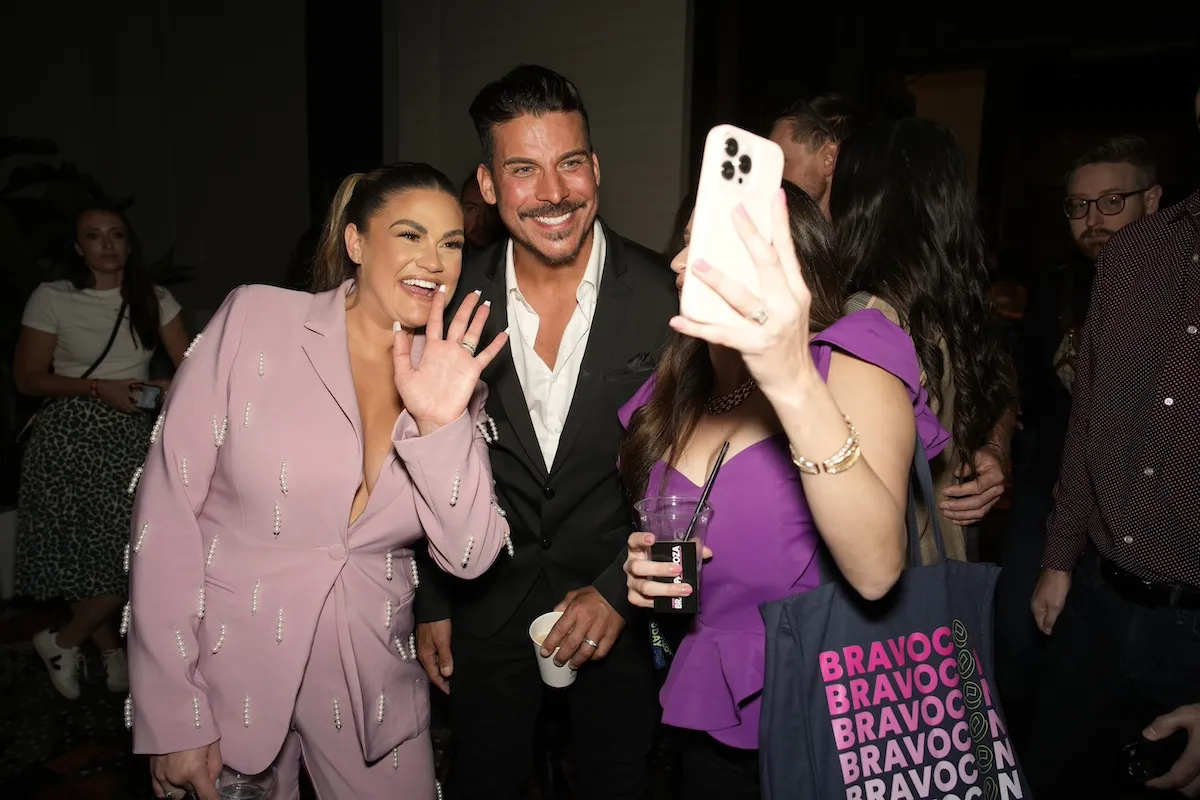 Brittany Cartwright and Jax Taylor pose for a photo for a fan at BravoCon 2023