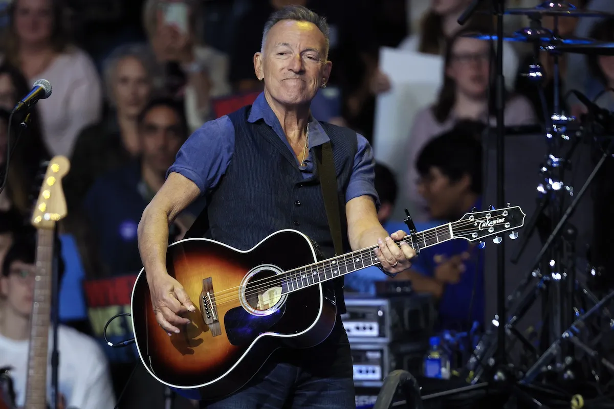 Bruce Springsteen playing guitar at a rally for Kamala Harris