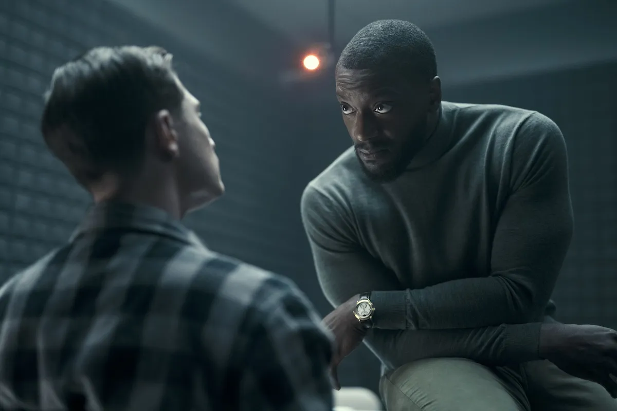 Alex Cross sits on a table as he interrogates a suspect in 'Cross'