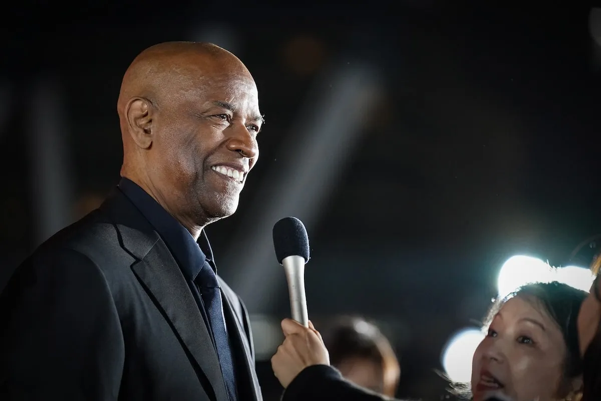 Actor Denzel Washington laughs with a reporter during his Gladiator II press tour