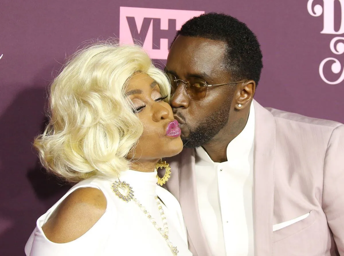 Sean 'Diddy' Combs wears a suit and kisses his mom, Janice, on the cheek.