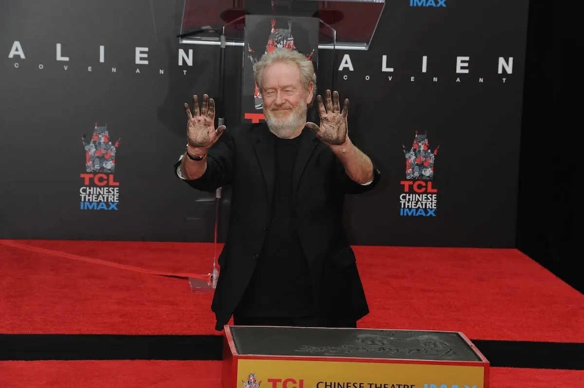 Sir Ridley Scott holds up his hands at his 2017 hand and footprint ceremony at TCL Chinese Theatre IMAX