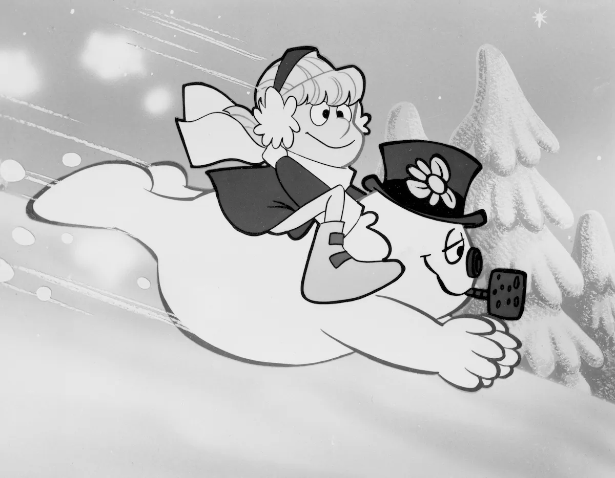 Black and white image of little girl riding on snowman's back from the animated movie 'Frosty the Snowman' 