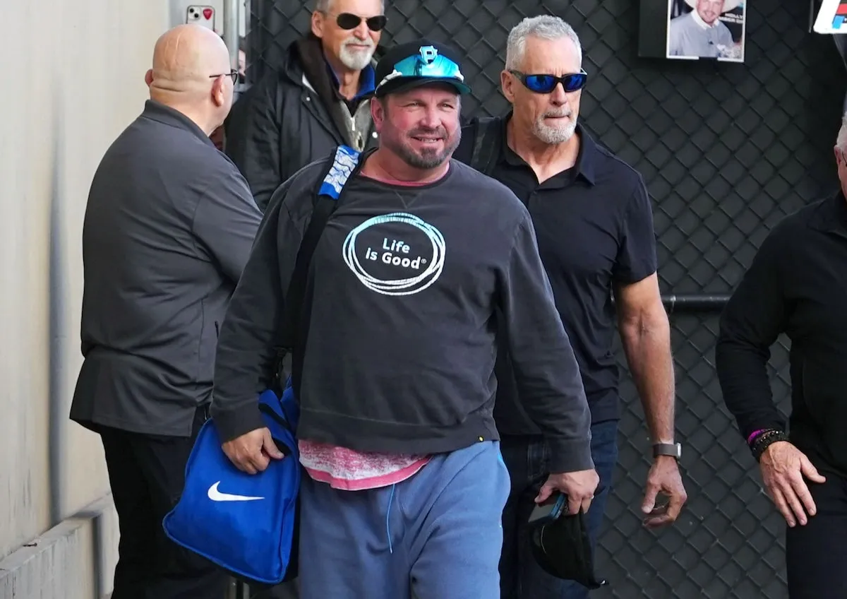 Wearing a gray sweatshirt and blue sweatpants, Garth Brooks greets fans outside of Jimmy Kimmel Live studios