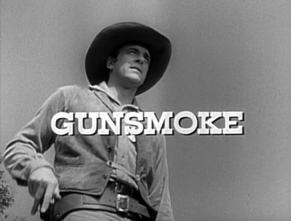 Black and white image of a man reaching for his gun from the title credits of 'Gunsmoke'