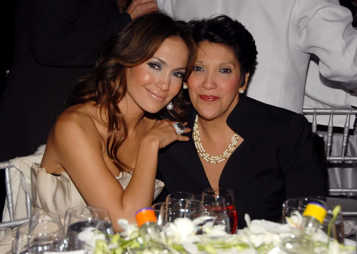 Jennifer Lopez and her mother sit at a table together.