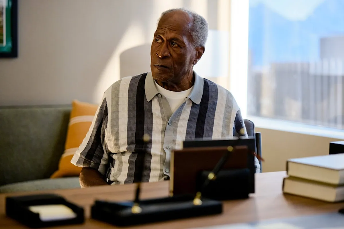 John Amos sitting in front of a desk in the 'Suits LA' pilot episode