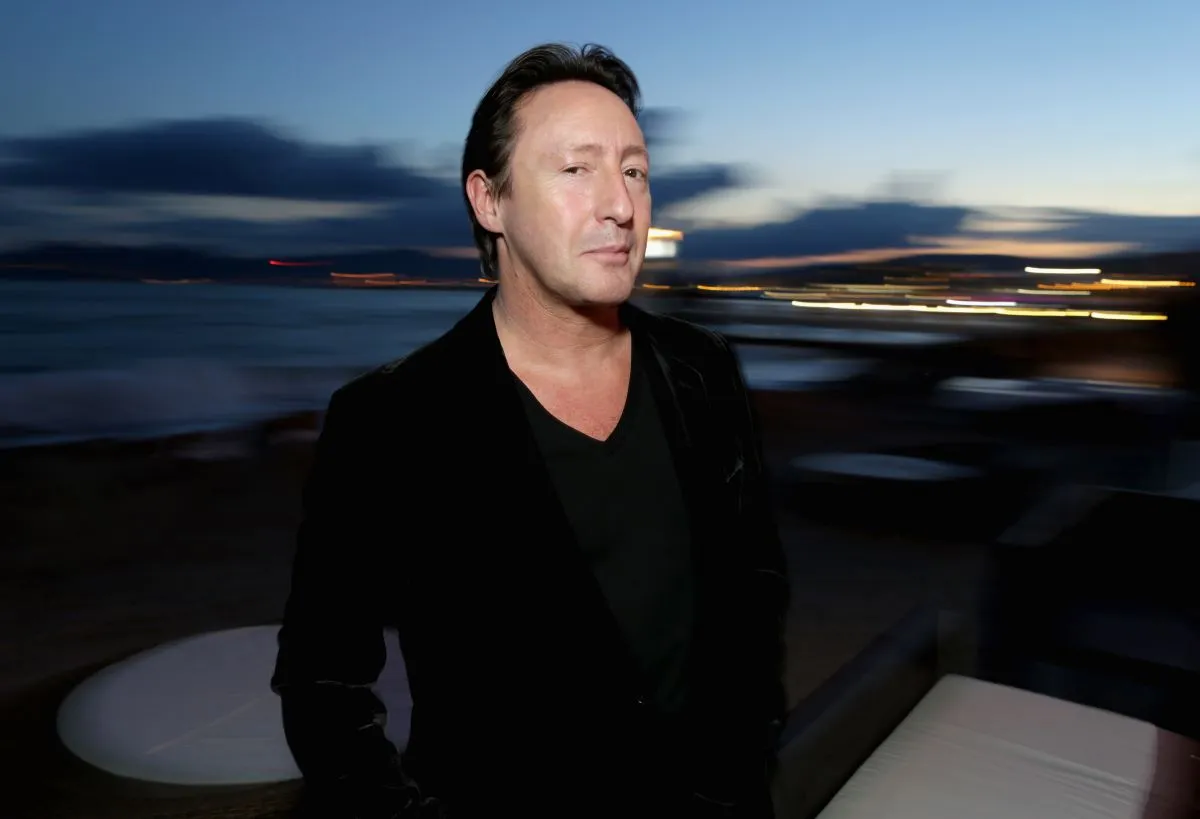 Julian Lennon wears a black shirt and stands outside.