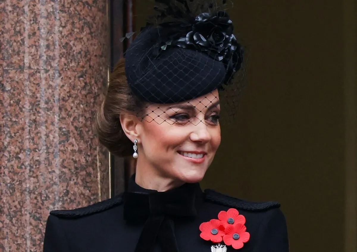 Kate Middleton looks on from a balcony during the annual Service of Remembrance at The Cenotaph