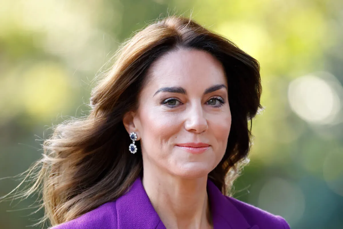 Kate Middleton, whose 'sense of normalcy' at home is 'key' to her recovery from cancer, smiles wearing purple