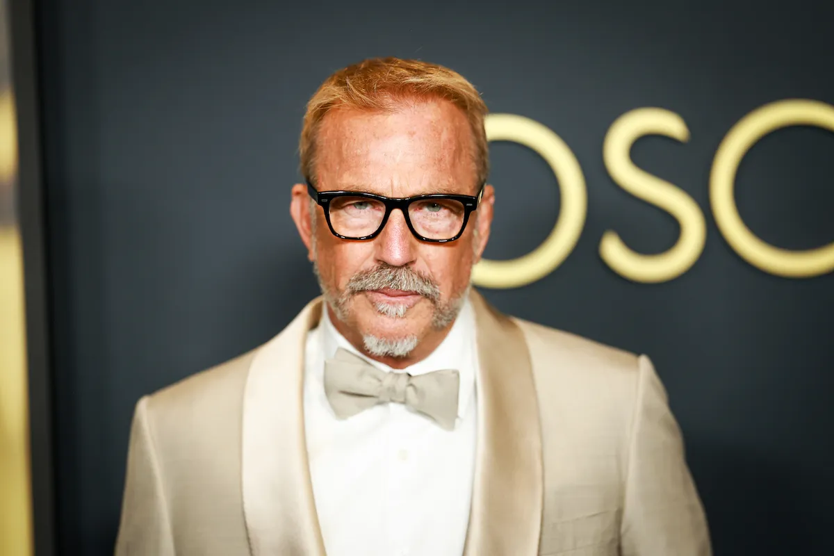 Kevin Costner wearing a gold suit and matching bow tie with a white button-up underneath at the Governors Awards