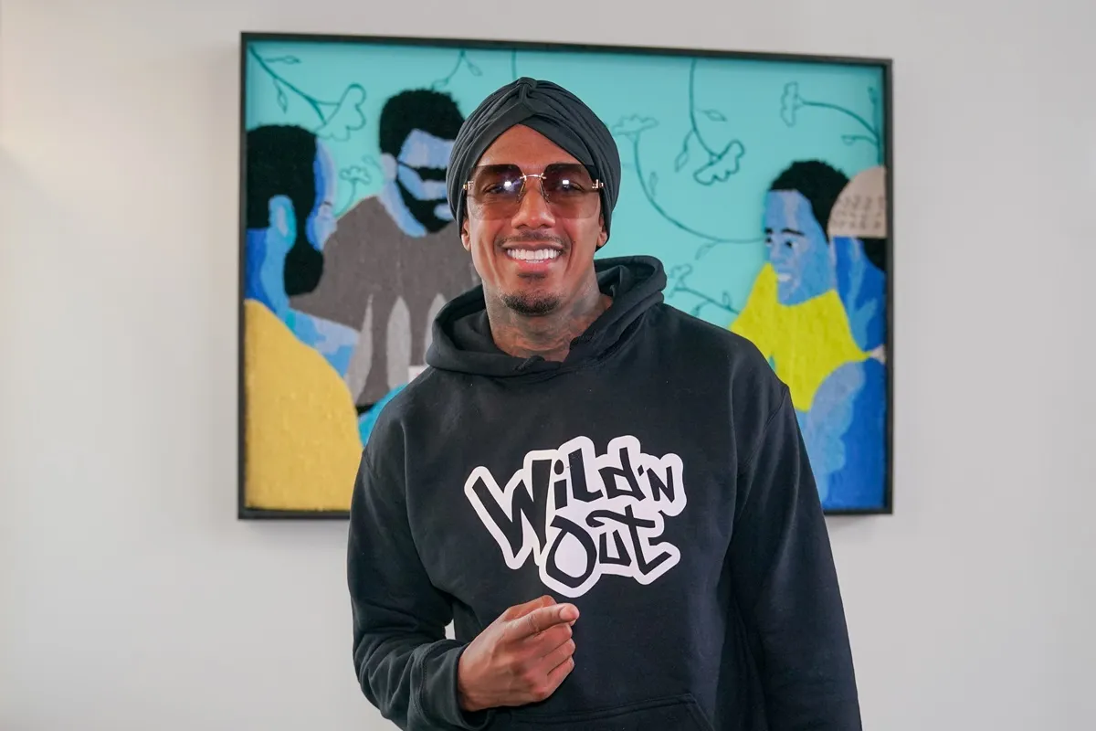 Nick Cannon posing in a black 'Wild N' Out' hoodie at the Creators House Remix at The Gathering Spot.