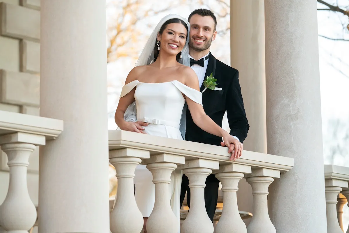 Taylor and Garrett from 'Love Is Blind' Season 7 pose for a photo on a balcony on their wedding day