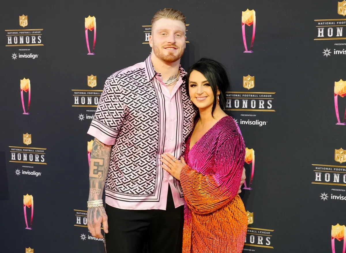 Maxx Crosby and his wife, Rachel Washburn, pose on the red carpet together at the Annual NFL Honors