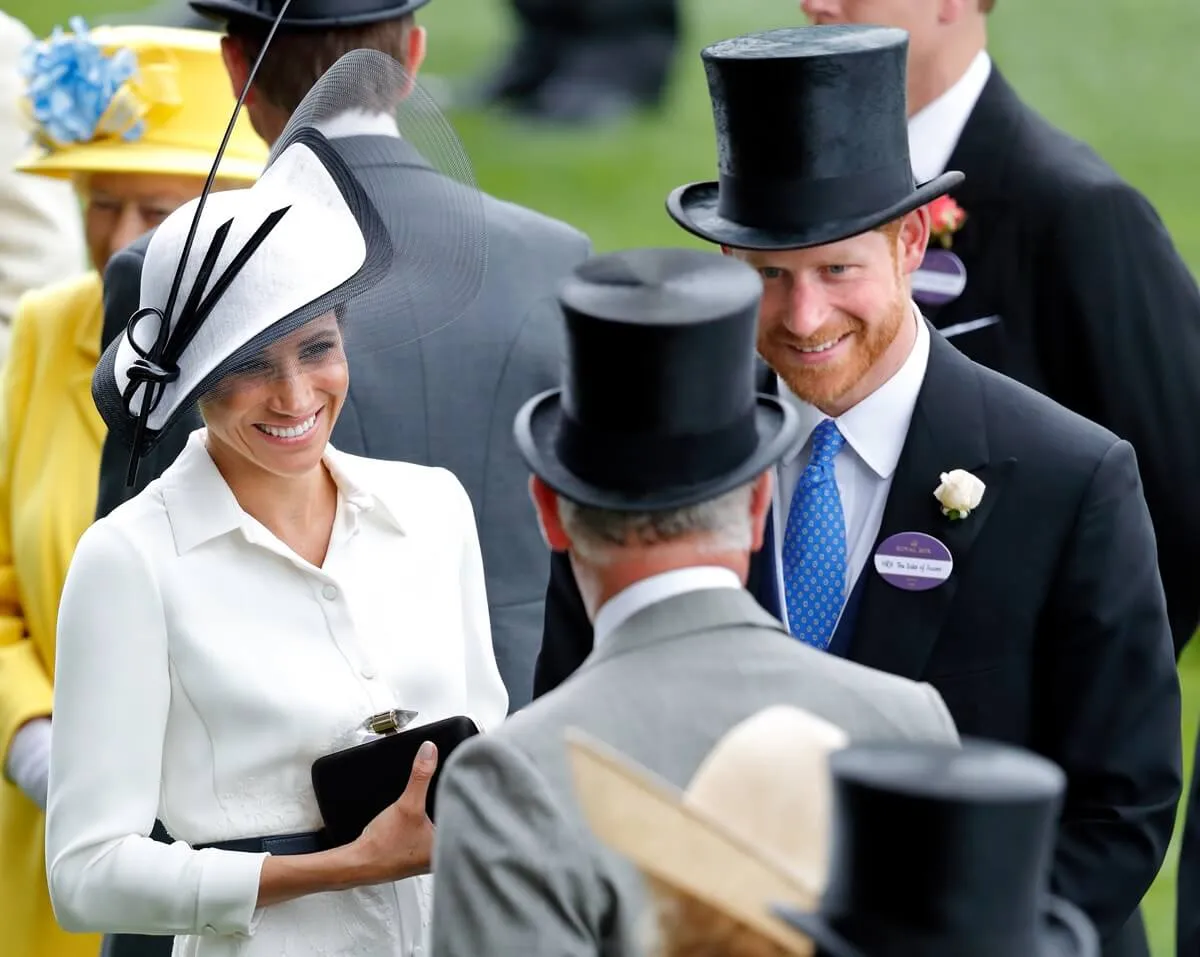 Meghan Markle and Prince Harry talking to then-Prince Charles during day 1 of Royal Ascot in 2018