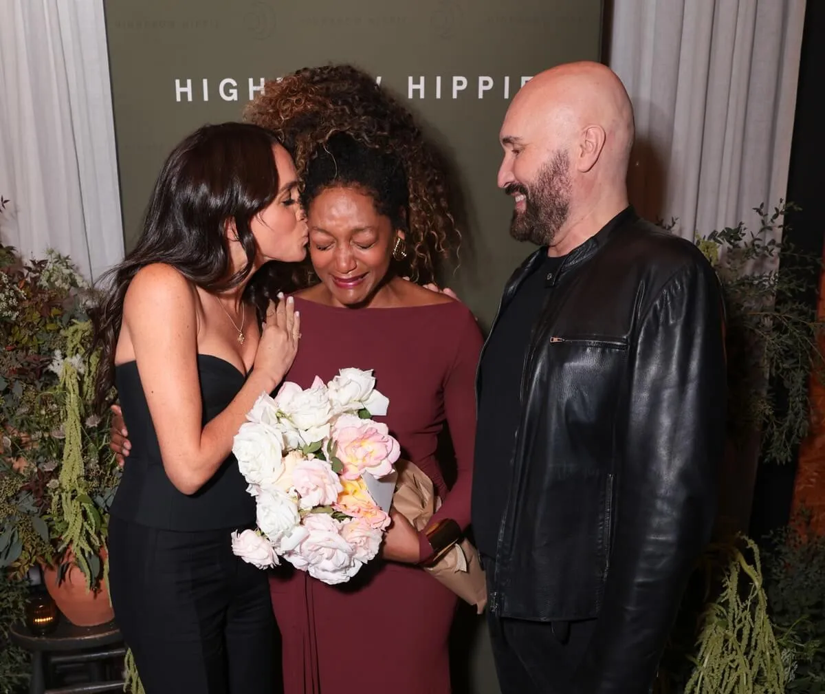 Meghan Markle kissing Kadi Lee and posing with Serge Normant at the Launch of Highbrow Hippie Haircare & Wellness