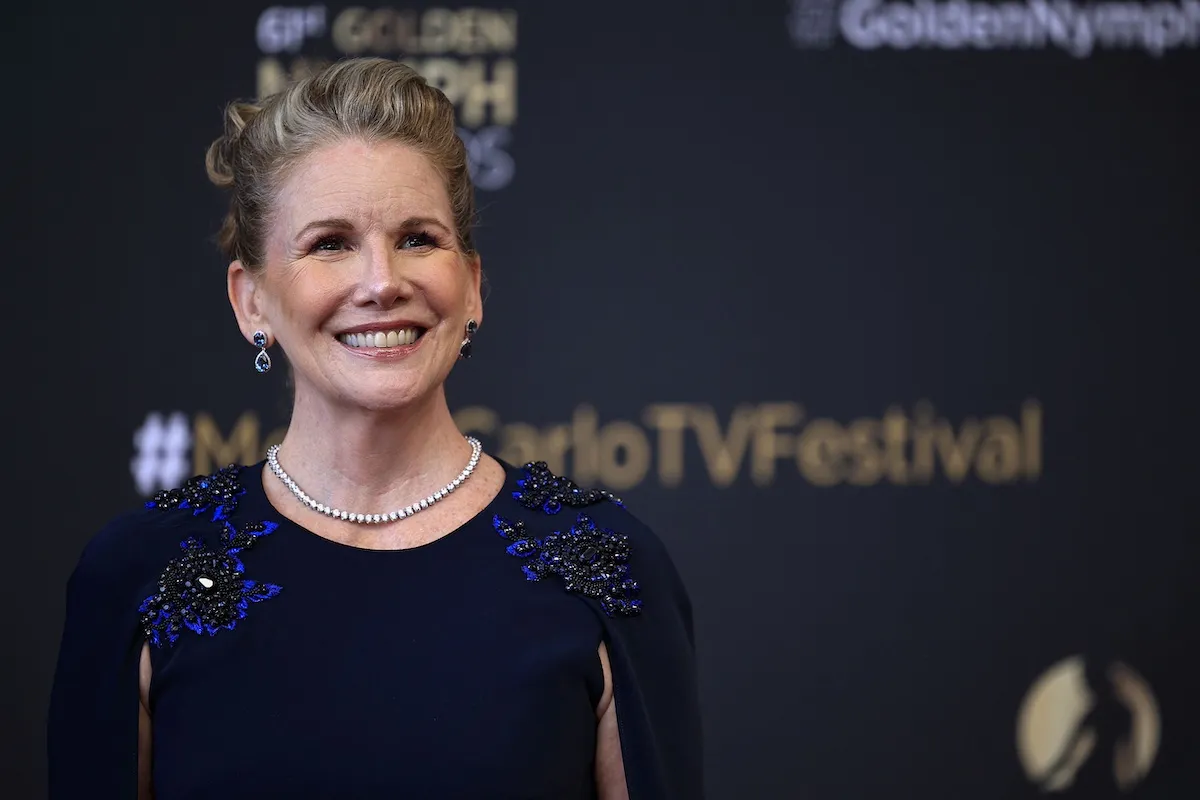 Smiling Melissa Gilbert poses for a photo on a film festival red carpet