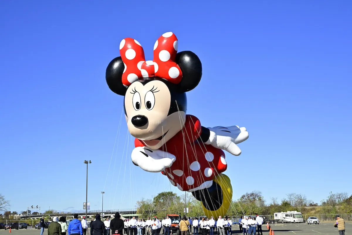 Large Minnie Mouse balloon floating in the sky ahead of the 2024 Macy's Thanksgiving Day Parade