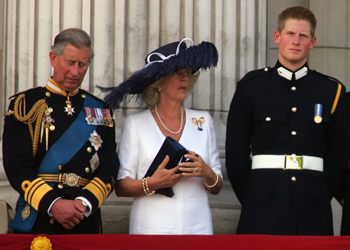 Now-King Charles and Queen Camilla along with Prince Harry watch a flypast from the Buckingham Palace balcony