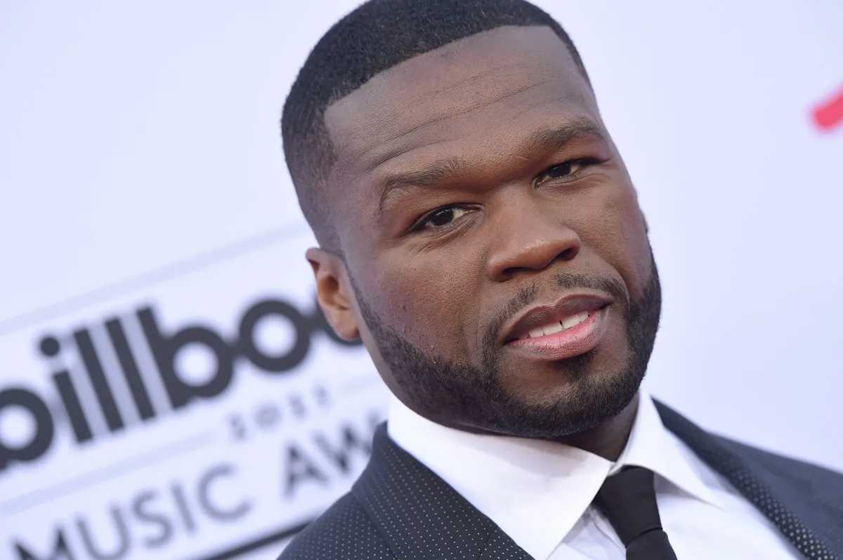 50 Cent posing at the Billboard awards in a suit.