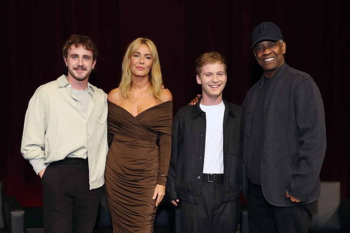 Cast members Paul Mescal, Connie Nielsen, Fred Hechinger, and Denzel Washington smile and pose onstage during a "Gladiator II" Special Screening