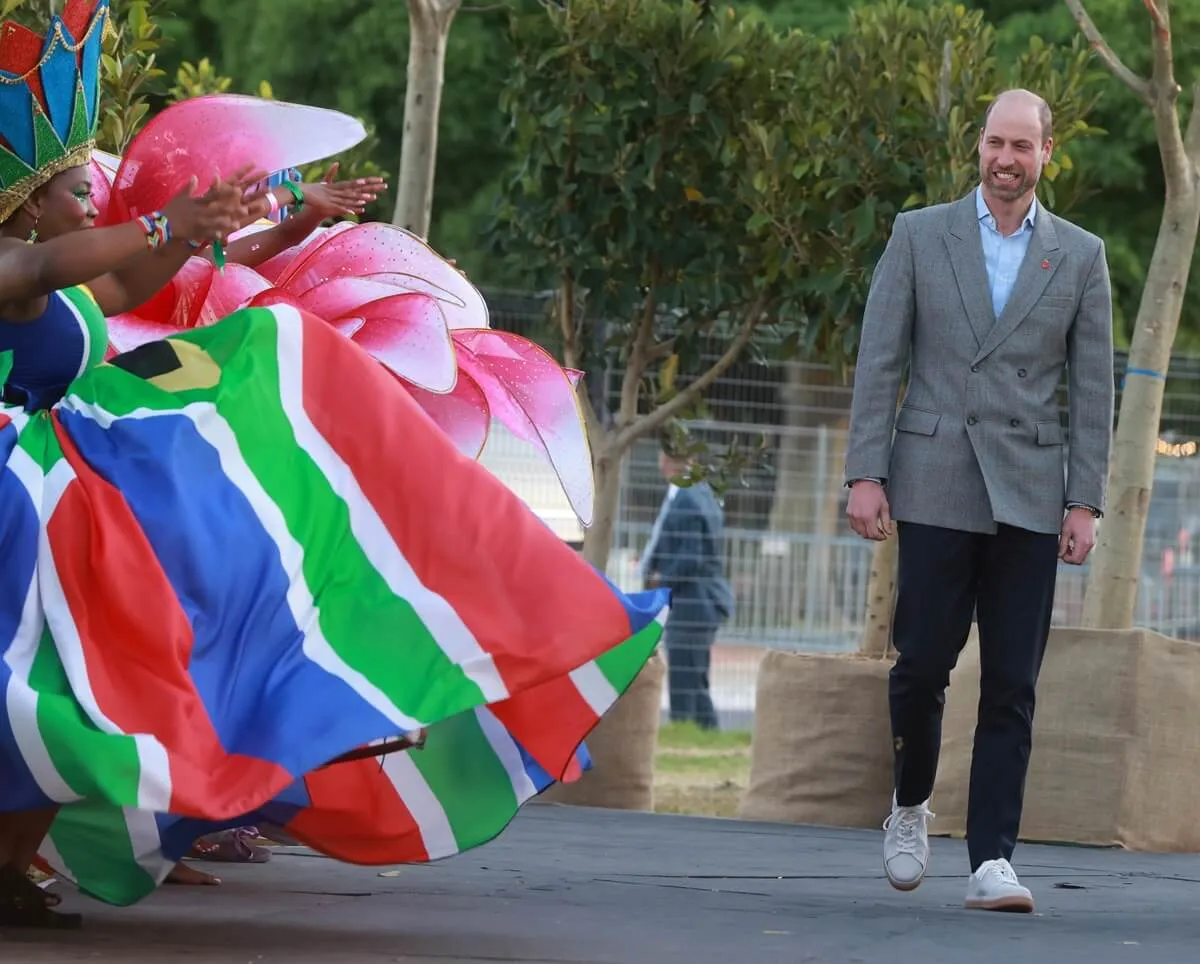 Performers dance as Britain's Prince William arrives for the 2024 Earthshot Prize awards ceremony