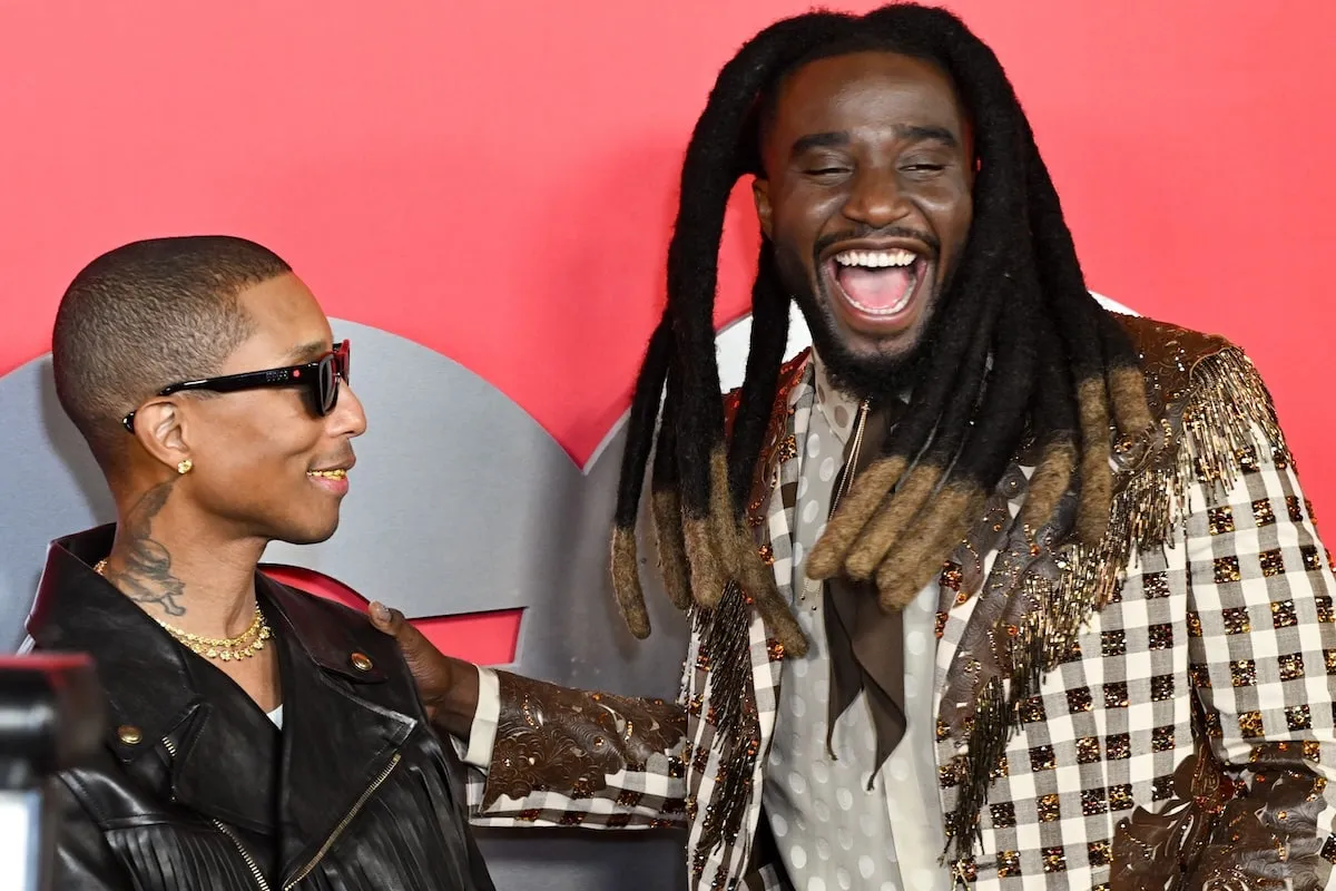 GQ Man of the Year Pharrell Williams laughs with Shaboozey on the red carpet