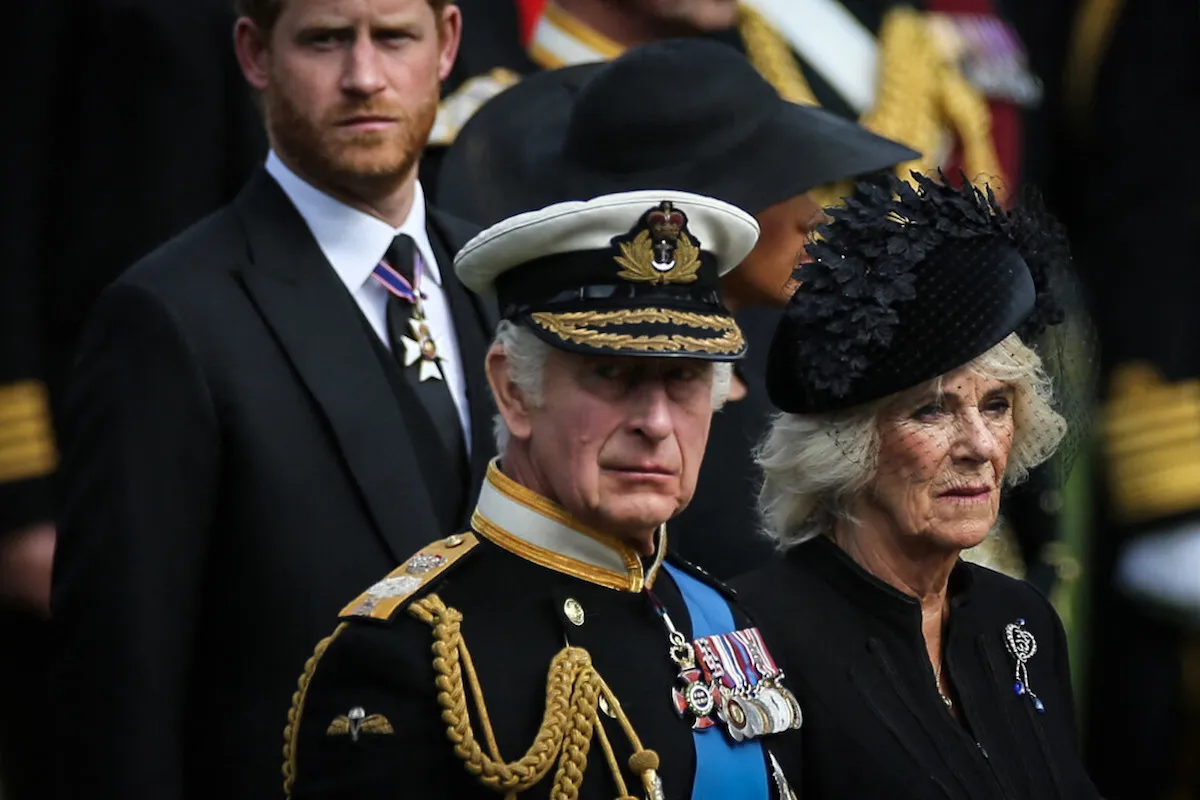 Prince Harry, King Charles III, and Queen Camilla stand together in 2022