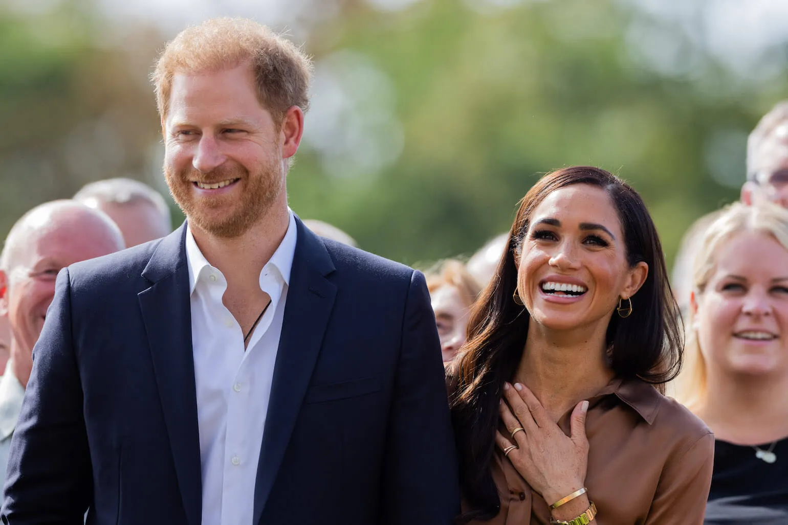 Prince Harry and Meghan Markle walking together and laughing at Invictus Games